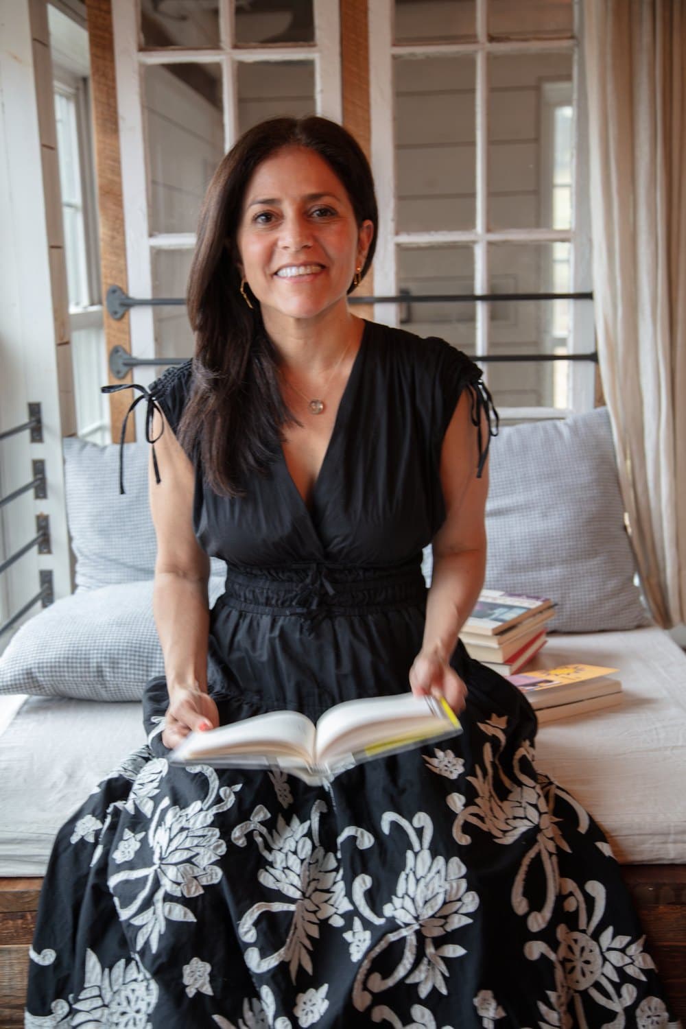 Lisa Weinert, founder of Narrative Healing, holding an open book