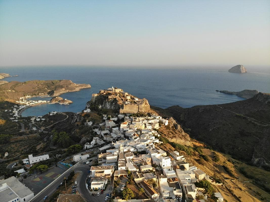 The whitewashed town of Chora on Kythera seen from above, its Venetian castle on the headland over Kapsali bay